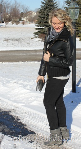 Black Skinny Pants, Black Leather Coat with Short Grey Boots, a Grey Scarf and Big Curly Hair
